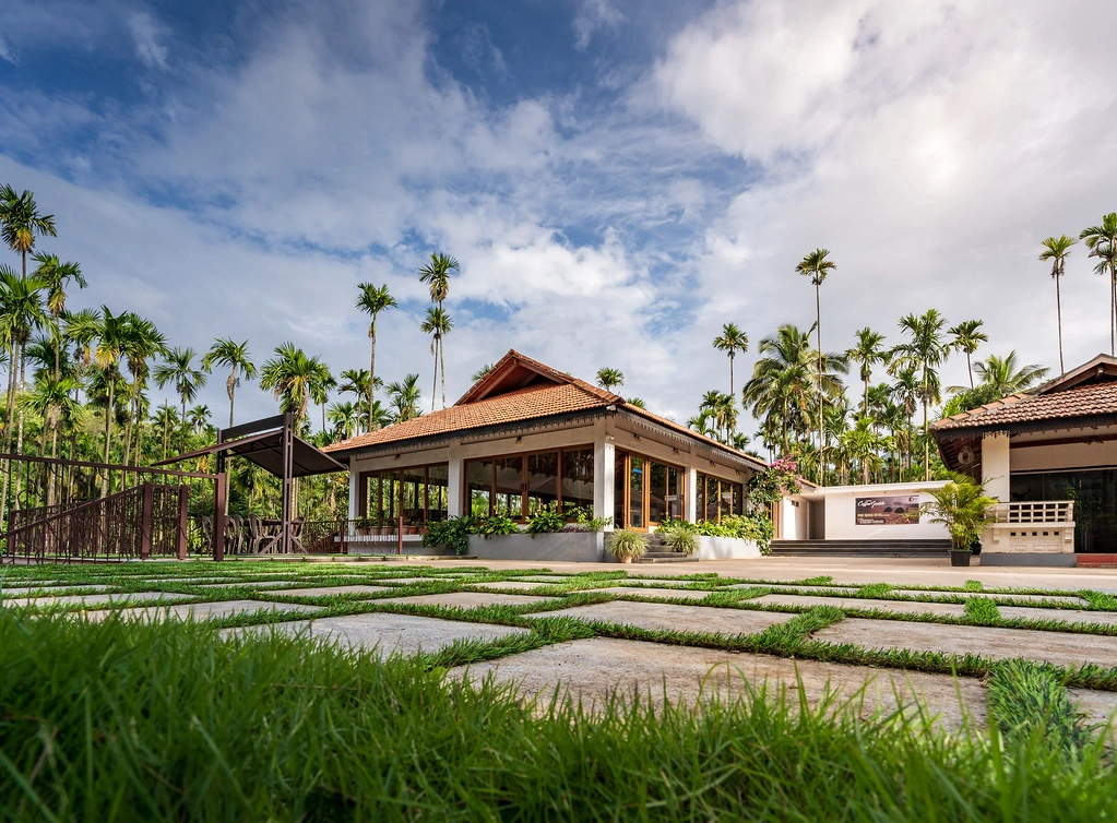 Exterior view of Coffee Gudda Resort surrounded by coffee plantations in the Western Ghats, Chikmagalur